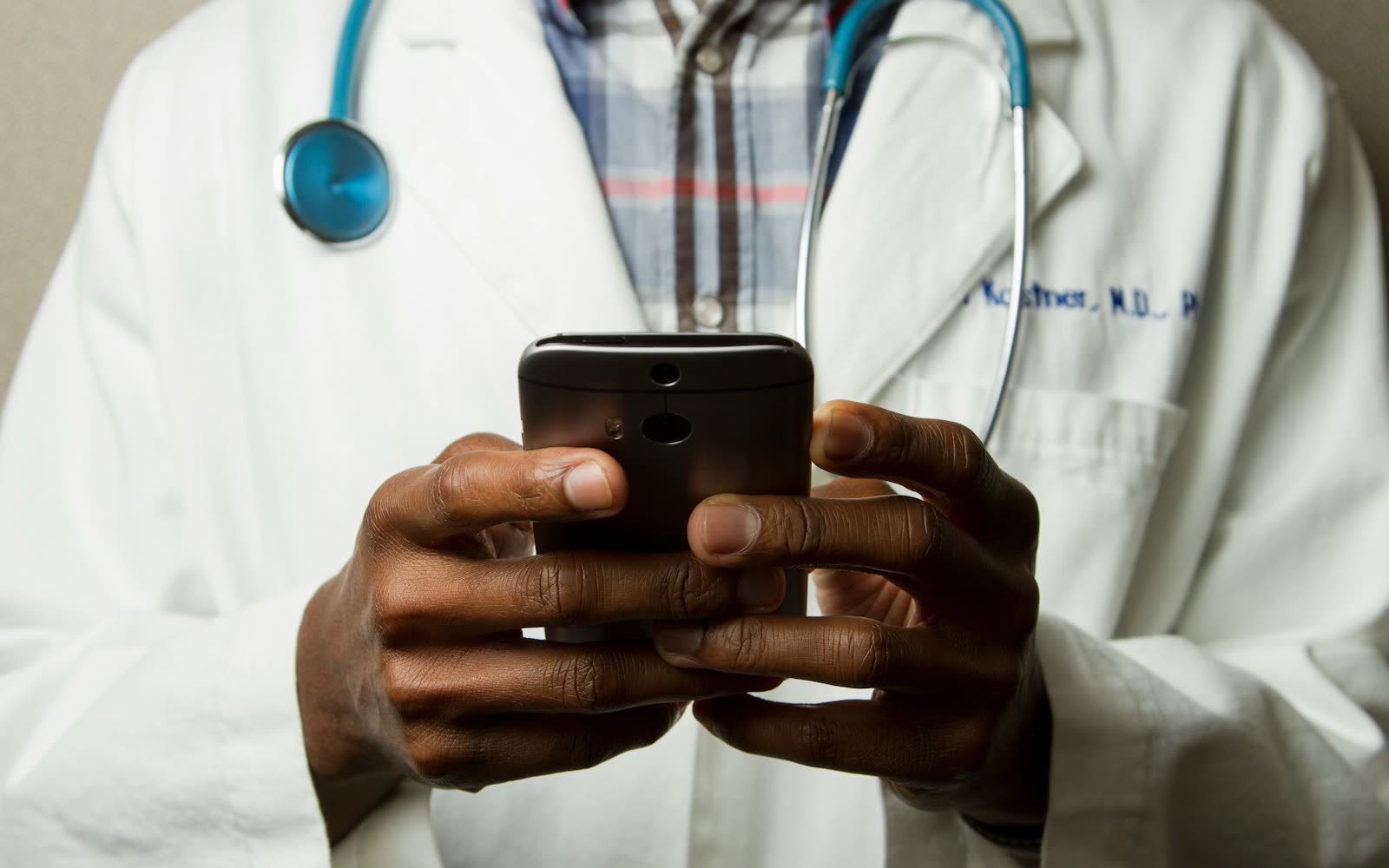 A clinician checking their phone between appointments